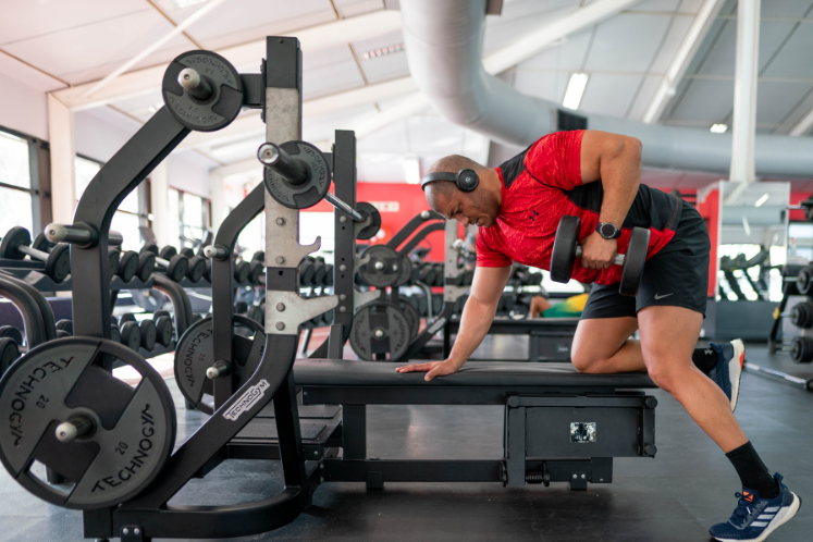 Man in gym lifting weights