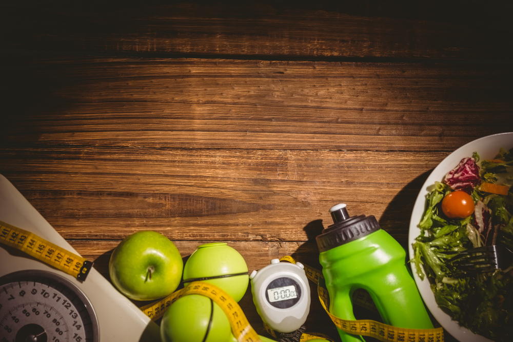 Indicators of healthy lifestyle on wooden table